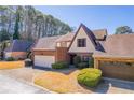 Charming home with attached garages and manicured landscaping on a sunny day at 2 Westchester Sq, Decatur, GA 30030