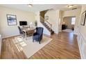 Bright office space features a large desk, comfortable chair, and stairs leading to upper level at 1399 Dukes Creek Nw Dr, Kennesaw, GA 30152