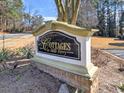 The Cottages at Bells Ferry neighborhood sign with decorative details and landscaping on a sunny day at 2357 Barrett Cottage Pl, Marietta, GA 30066