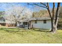 Classic home boasts a brick facade, covered porch, and a serene yard with mature trees and greenery at 304 Mercer Dr, Jonesboro, GA 30236