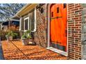 Inviting front porch with colorful tiled flooring and an orange front door featuring black wrought iron hardware at 1352 Emory Ne Rd, Atlanta, GA 30306