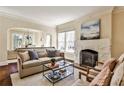 Bright living room featuring a stone fireplace, neutral decor, and an open layout to the dining area at 1352 Emory Ne Rd, Atlanta, GA 30306