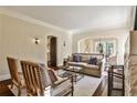 Comfortable living room with neutral tones, a stone fireplace, and seamless flow to the dining area at 1352 Emory Ne Rd, Atlanta, GA 30306