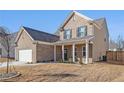 Charming two-story home featuring a welcoming front porch and well-kept lawn at 1593 Maston Rd, Auburn, GA 30011