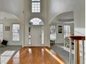 Inviting foyer showcases hardwood floors and dining area with archways at 3723 Mossbrook Ter, Suwanee, GA 30024