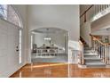 Bright foyer featuring hardwood floors, staircase, and dining room entrance at 3723 Mossbrook Ter, Suwanee, GA 30024