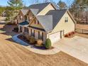 Spacious two-story home showcases a large driveway, side-entry garage, and manicured yard at 4220 Lindsey Way, Conyers, GA 30013