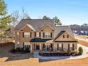 Beautiful two-story brick home boasts a well-maintained lawn and inviting curb appeal at 4220 Lindsey Way, Conyers, GA 30013
