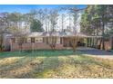 Charming brick home featuring a lush green lawn and mature trees, enhancing its curb appeal at 4183 Hideaway Dr, Tucker, GA 30084