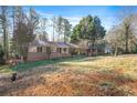 Ranch-style home boasts a well-manicured lawn and mature trees, blending comfort with outdoor beauty at 4183 Hideaway Dr, Tucker, GA 30084