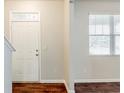 Inviting entryway featuring a white front door, hardwood floors, and a window for natural light at 450 Lake Ridge Ln, Fairburn, GA 30213