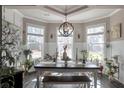 Elegant dining area with wainscoting, modern lighting, and lots of natural light from three windows at 531 Eagles Nest Cir, Auburn, GA 30011