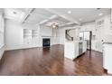 Open-concept living space with fireplace, hardwood floors, kitchen island, and stainless steel appliances at 2230 Mulsanne Dr, Lithonia, GA 30058