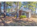 Inviting home with natural surroundings and charming curb appeal at 9090 Dorsey Rd, Riverdale, GA 30274