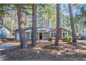 Cozy home facade with mature trees and a well-maintained yard at 9090 Dorsey Rd, Riverdale, GA 30274