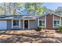 Home exterior showcasing a brick accent and manicured landscaping at 9090 Dorsey Rd, Riverdale, GA 30274