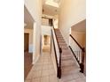 Bright foyer with tiled floor, carpeted stairs, and high ceilings at 2030 Calmwater Ct, Suwanee, GA 30024