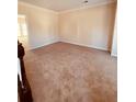 Empty living room features neutral walls, plush carpeting, and ample natural light at 2030 Calmwater Ct, Suwanee, GA 30024