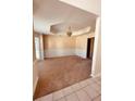 Spacious living room with neutral carpet, chair rail, and decorative chandelier at 2030 Calmwater Ct, Suwanee, GA 30024