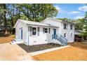 Beautiful white brick home with blue shutters, a freshly landscaped yard, and a cozy feel at 6539 Hayes Dr, Riverdale, GA 30274