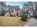 Beautiful home showcasing a classic design with a brick facade and mature trees at 1579 Mayflower Sw Ave, Atlanta, GA 30311