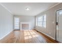 Bright living room with hardwood floors, fireplace and natural light from the large window at 1579 Mayflower Sw Ave, Atlanta, GA 30311