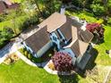 Aerial view of house with landscaped yard, brick patio, and pool surrounded by trees at 2660 Portabella Ln, Cumming, GA 30041