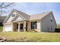 Well-maintained home with a brick and siding exterior, complemented by a lush green lawn and tidy landscaping at 7995 Brewton Creek Dr, Cumming, GA 30028