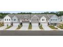 An attractive row of townhomes features varied designs, garages, and neat landscaping at 537 Tuskegee St # 48, Mcdonough, GA 30252