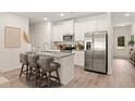 Modern kitchen with stainless steel appliances, granite countertops, and stylish island with seating at 537 Tuskegee St # 48, Mcdonough, GA 30252