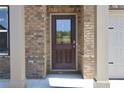 Charming brick home featuring a front door with glass and decorative columns at 642 Egrets Landing #66, Covington, GA 30014