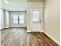 Spacious living area with a door to the backyard, and natural light from multiple windows at 642 Egrets Landing #66, Covington, GA 30014