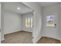 Bright entryway featuring wood-look flooring, a window and a white front door at 643 Egrets Landing Lndg, Covington, GA 30014