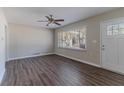 Bright living room with wood-look floors, neutral walls, ceiling fan and natural light at 2777 Luther Dr, Atlanta, GA 30344