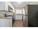Modern kitchen with stainless steel appliances, granite countertops, and sleek white cabinets at 1433 Dennis Dr, Decatur, GA 30032