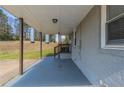 Spacious carport area with concrete flooring and view of the yard at 1925 Campbellton Sw Rd, Atlanta, GA 30311
