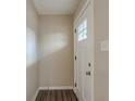 Bright entryway with hardwood flooring and a white front door at 1925 Campbellton Sw Rd, Atlanta, GA 30311