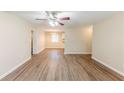 Spacious living room with laminate floors and an open view of the kitchen and dining area at 3192 Belfort Se Rd, Atlanta, GA 30354