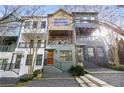 Charming multi-level townhome exterior with a colorful facade, balcony, and inviting entryway at 754 Aerial Way, Atlanta, GA 30312