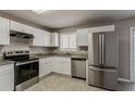 Bright kitchen with stainless steel appliances, granite countertops, and white cabinets at 810 N Carter Dr, Jonesboro, GA 30236