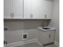Clean laundry room featuring white cabinets and countertop with sink at 491 Fescue Nw Ct, Kennesaw, GA 30144