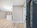 Entryway view leading to the kitchen showcasing an open concept floor plan with hardwood floors at 2308 Mark Trl, Decatur, GA 30032