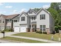 Attractive two-story home with a double garage, stone accents, and a well-kept lawn at 4416 Water Mill Dr, Buford, GA 30519
