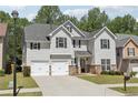 Beautiful two-story home with gray siding, black shutters, and a well-maintained front yard at 4416 Water Mill Dr, Buford, GA 30519
