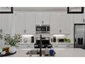 Bright kitchen featuring white cabinets, stainless steel appliances, and a stylish black faucet at 511 Burton Dr # 805, Alpharetta, GA 30009