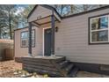 Inviting front porch with fresh paint, updated lighting, and a freshly painted front door at 578 Center Hill Nw Ave, Atlanta, GA 30318
