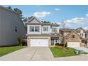 View of home with lawn and driveway with gray siding and brick two car garage at 103 Bryon Ln, Acworth, GA 30102