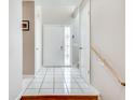 Inviting foyer with tile floors, bright entryway, and staircase with wooden handrail at 2000 Variations Dr, Atlanta, GA 30329