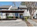 Well-maintained townhouse with a convenient carport, manicured landscaping, and a welcoming front entrance at 2000 Variations Dr, Atlanta, GA 30329