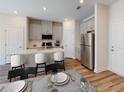 Modern kitchen with stainless steel appliances, stylish countertops, and seating at the breakfast bar at 329 White Tail Rd, Stockbridge, GA 30253